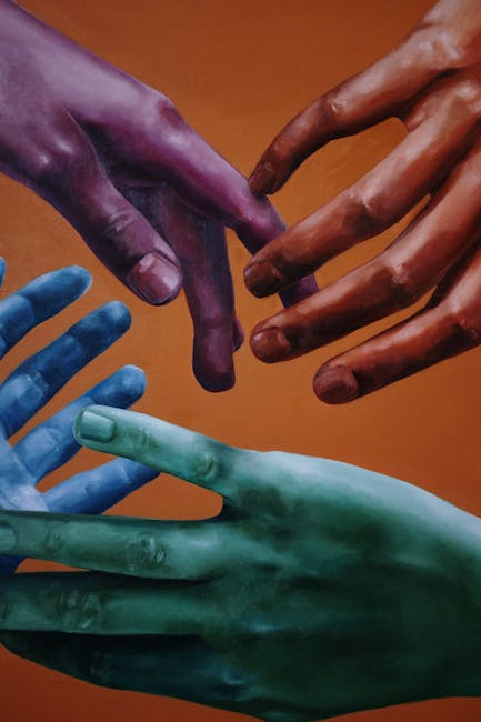 Artistic portrayal of multicolored hands on a vibrant orange background, symbolizing unity and diversity.